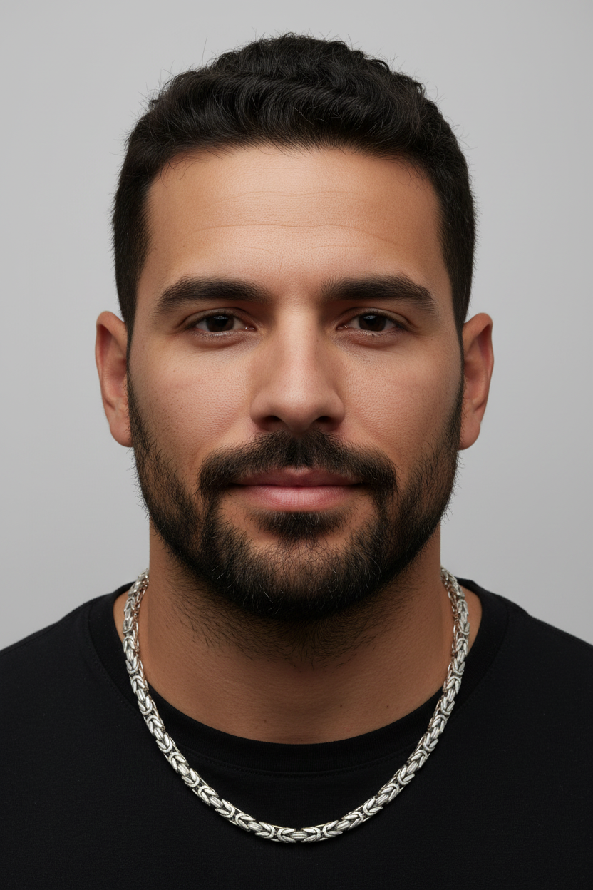 Man wearing a black shirt and silver chain necklace against a gray background. Byzantine_Chain_Silver_Heavy_24.