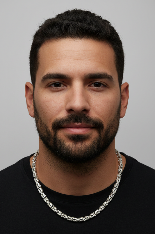 Man wearing a black shirt and silver chain necklace against a gray background. Byzantine_Chain_Silver_Heavy_24.
